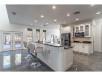 Well-lit kitchen with a spacious center island and access to an outdoor space at 352 Radisson Pl, Oviedo, FL 32765