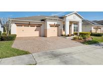 Charming single-story home with a three-car garage and a beautiful brick paver driveway at 4909 Drawdy Ct, St Cloud, FL 34772