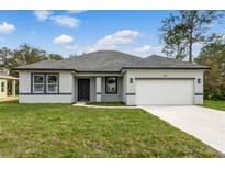 Charming single-story home featuring a well-manicured lawn, neutral paint, and a two-car garage at 505 St Johns Ct, Kissimmee, FL 34759