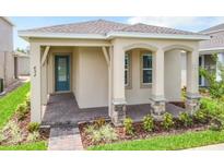 Charming single-story home featuring a covered porch with stylish stone accents and well-maintained landscaping at 652 Kimber Ln, Debary, FL 32713