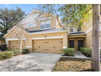 Charming townhouse featuring a two-car garage and well-maintained landscaping at 8031 Enchantment Dr # Ge, Windermere, FL 34786