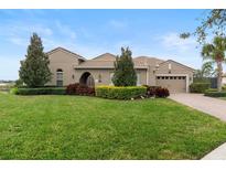 Beautiful single-story home with a well-manicured lawn and mature landscaping at 8774 Bayview Crossing Dr, Winter Garden, FL 34787