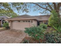 Charming home with well-maintained front yard and attached two-car garage at 302 Bridie Ct, Winter Springs, FL 32708