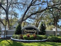 Attractive Brantley Terrace entrance sign with lush landscaping and mature trees creates a welcoming feel to the neighborhood at 583 Brantley Terrace Way # 303, Altamonte Springs, FL 32714