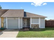 Charming one-story home featuring a one car garage, small front yard and decorative rockwork at 7250 Oak Meadows Cir, Orlando, FL 32835