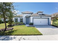 Charming single-Gathering home boasts a well-manicured lawn and welcoming curb appeal at 113 Azure Mist Way, Daytona Beach, FL 32124