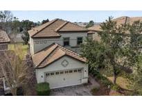 Charming two-story home featuring a two-car garage and a well-maintained tile roof at 1494 Moon Valley Dr, Davenport, FL 33896