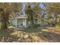 Charming single-story home with a welcoming front porch and lush landscaping, creating a serene curb appeal at 1744 E Welch Rd, Apopka, FL 32712