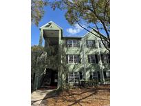 Inviting exterior view of a charming condominium building with well-maintained landscaping at 1997 Dixie Belle Dr # 1997C, Orlando, FL 32812