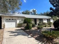 Charming single-story home featuring a well-manicured front yard and a one car garage at 200 Ventura Dr, Sanford, FL 32773