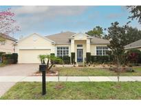 Charming home featuring a well-manicured lawn, a brick driveway, and a beautiful, light-colored exterior at 2165 Westbourne Dr, Oviedo, FL 32765