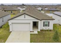 Charming single-story home with a two-car garage and neutral-colored exterior in a Gathering-friendly neighborhood at 5861 Bar Ranch Rd, St Cloud, FL 34771