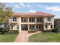 Stunning two-story home with tile roof, beautiful landscaping and brick driveway at 8424 Lake Burden Cir, Windermere, FL 34786