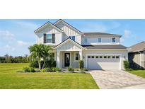 Charming two-story home featuring a well-manicured lawn and a welcoming two-car garage at 1832 Farnham Dr, Ocoee, FL 34761