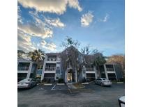 A well-maintained condominium complex shows serene blue exteriors and convenient parking spots at 2516 Grassy Point Dr # 206, Lake Mary, FL 32746
