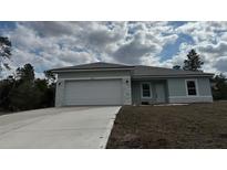 Charming one-story home with attached garage and a freshly poured concrete driveway at 2942 Sw 162Nd St, Ocala, FL 34473
