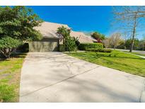 Lovely single-story home featuring an attached two-car garage, attractive landscaping, and a concrete driveway at 5016 Fawn Ridge Rd, Orlando, FL 32819