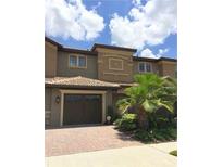 Charming two-story townhome with a well-manicured lawn and a convenient attached garage, with great curb appeal at 8950 Azalea Sands Ln # 8950, Champions Gate, FL 33896