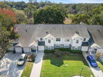 Spacious townhomes featuring attached garages, well-maintained lawns, and a serene, tree-filled backdrop at 923 Lexington Pkwy # 14, Apopka, FL 32712