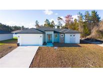 Charming single-story home with modern design, white accents, and a spacious two-car garage at 2629 Sw 163Rd Pl, Ocala, FL 34473