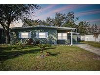 Charming single-story home featuring a well-maintained lawn and inviting curb appeal at 4900 Kempston Dr, Orlando, FL 32812