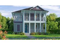 Charming two-story home featuring a welcoming front porch and second story balcony overlooking a manicured lawn at 10025 Dulbecco St, Orlando, FL 32827