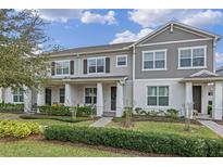 Charming two-story townhome with well-manicured lawn and inviting front porch at 10358 Spring Arbor Ln, Winter Garden, FL 34787