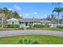 Charming single-story home with a well-maintained lawn, mature landscaping, and inviting front porch, exuding curb appeal at 111 Clark St, Oviedo, FL 32765