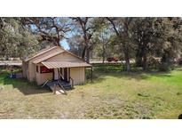 Charming vintage house nestled in a yard with mature trees at 1213 Cr 652, Bushnell, FL 33513