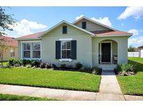 Charming one-story home with a well-manicured lawn and inviting front porch at 13812 Cepheus Dr, Orlando, FL 32828