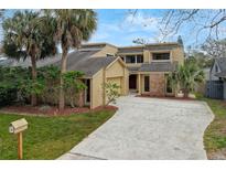 Inviting two-story home with a brick and siding exterior, featuring a spacious driveway and mature landscaping at 229 Springside Rd, Longwood, FL 32779