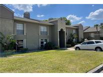 Condo building featuring well-maintained landscaping and covered entrance at 385 Wymore Rd # 200, Altamonte Springs, FL 32714