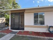 Charming single-story home featuring a screened front porch and landscaped yard at 1002 Stucki Ter, Winter Garden, FL 34787