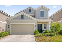 Charming two-story home featuring a two-car garage, landscaped yard, and inviting entrance at 1139 James Paul Rd, Davenport, FL 33837