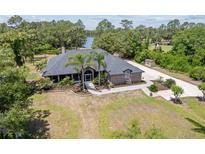 Expansive home with two palm trees, a winding walkway, and a beautifully landscaped garden bed at 1303 Sultan Cir, Chuluota, FL 32766