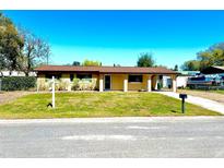 Charming single-story home with a well-maintained lawn and inviting curb appeal under a clear blue sky at 702 Apricot Dr, Ocoee, FL 34761