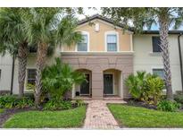 Charming townhome with a brick walkway, lush landscaping, and a welcoming entryway at 8948 Adriatico Ln, Kissimmee, FL 34747