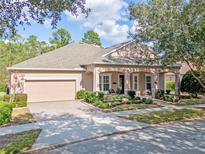 Charming single-story home with a well-manicured front yard and attached two-car garage at 1112 Heron Point Way, Deland, FL 32724