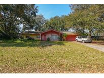 Charming one-story home featuring a colorful brick facade and a well-maintained lawn, offering a welcoming curb appeal at 1221 Forest Cir, Altamonte Springs, FL 32714