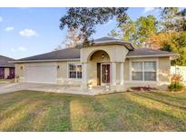 Charming single story home with well-maintained lawn and attached two car garage at 12991 Sw 72Nd Terrace Rd, Ocala, FL 34473