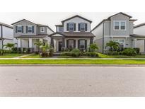 Charming two-story home with well-maintained lawn and landscaping in a modern community at 13819 Lanyard Way, Winter Garden, FL 34787