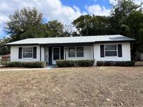 Charming single-story home featuring a well-maintained lawn and a welcoming entrance at 15081 Sw 35Th Cir, Ocala, FL 34473