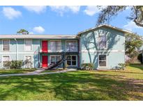 Inviting two-story apartment building features well-maintained landscaping and bright exterior paint at 1897 Caralee Blvd # 2, Orlando, FL 32822