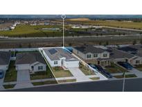 Beautiful aerial view of house showing the community and the exterior elevation with a well manicured lawn at 1934 Pond Pine Ct, Haines City, FL 33844