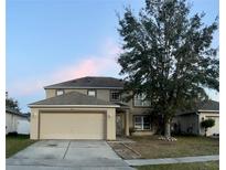 Charming two-story home with a two-car garage and a well-manicured lawn at 2037 Corner Tree Ct, Orlando, FL 32820
