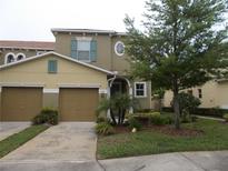 Two-story home featuring an attached two-car garage and nicely landscaped front yard at 318 Habitat Way, Sanford, FL 32773