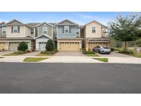 Charming townhomes showcasing a modern exterior with well-maintained lawns and inviting curb appeal at 4816 Cliveden Loop, Sanford, FL 32773