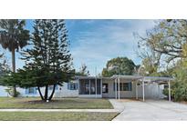 Charming single-story home features a covered parking area and a cozy screened-in porch at 623 Camellia Ct, Sanford, FL 32773