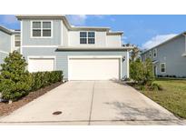 Charming two-story home with well-maintained lawn and attached two-car garage at 2623 Buena View Rd, Kissimmee, FL 34746