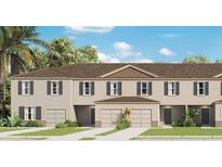 Charming two-story townhome with landscaped yard and attached garages at 3368 Private Oak Dr, Apopka, FL 32703